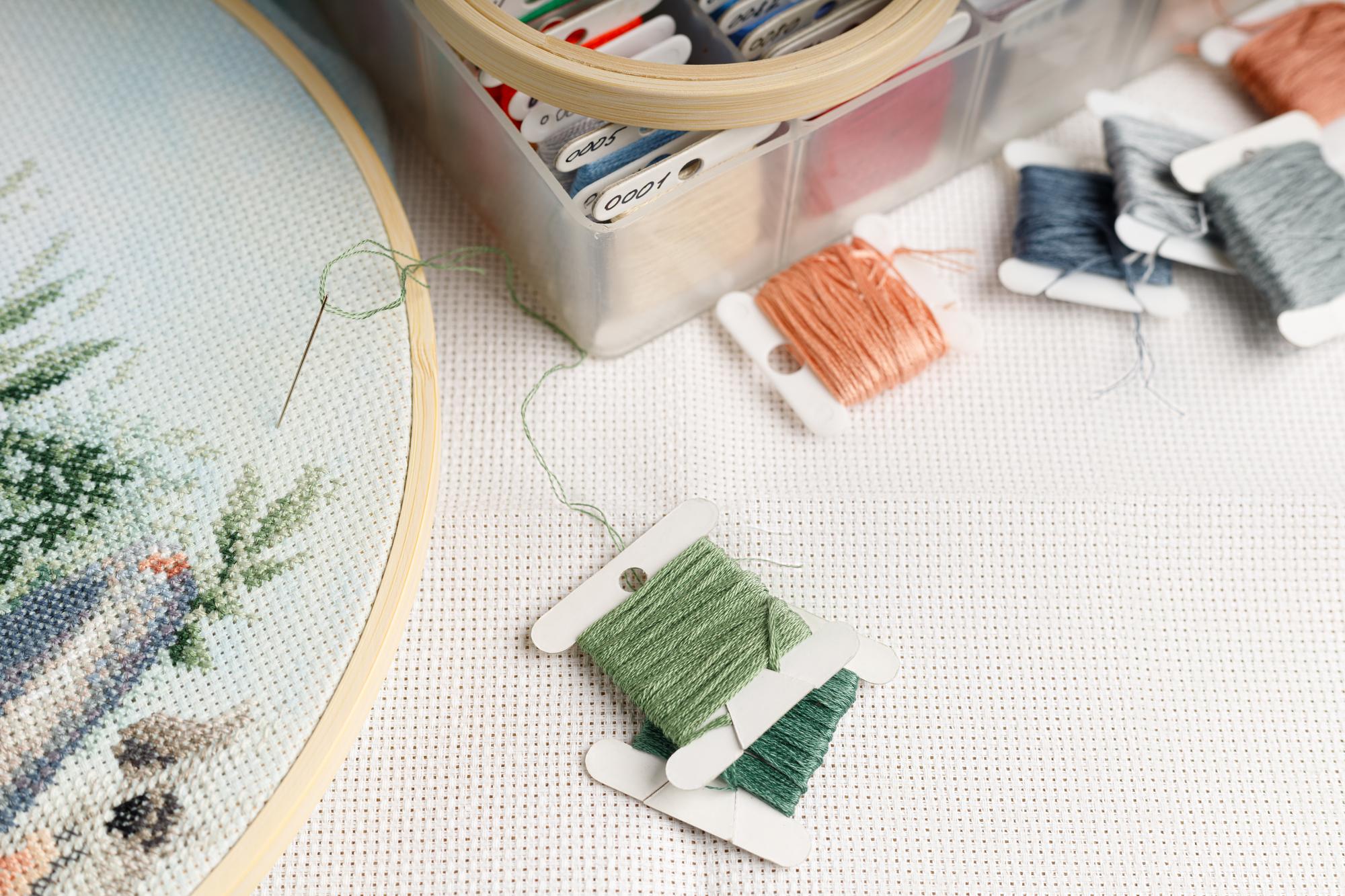atelier table with threads and embroidered samples